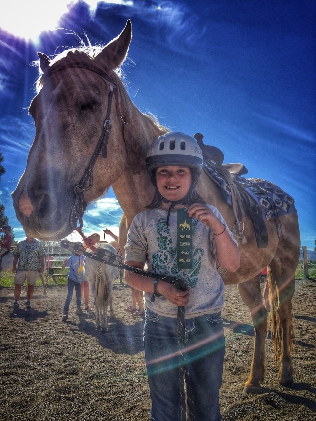 Avian with a ribbon from her first horse show.